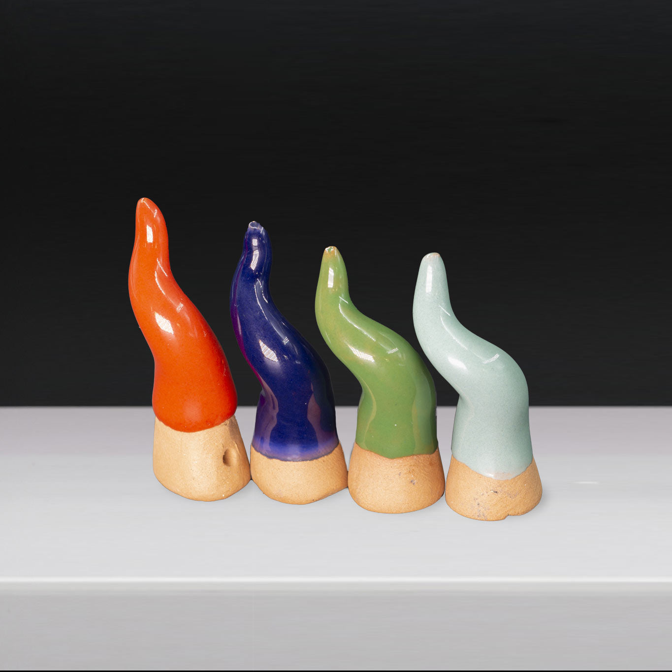 Mini ceramic countertop horn, assorted colors, in a pyramid box with graphite
